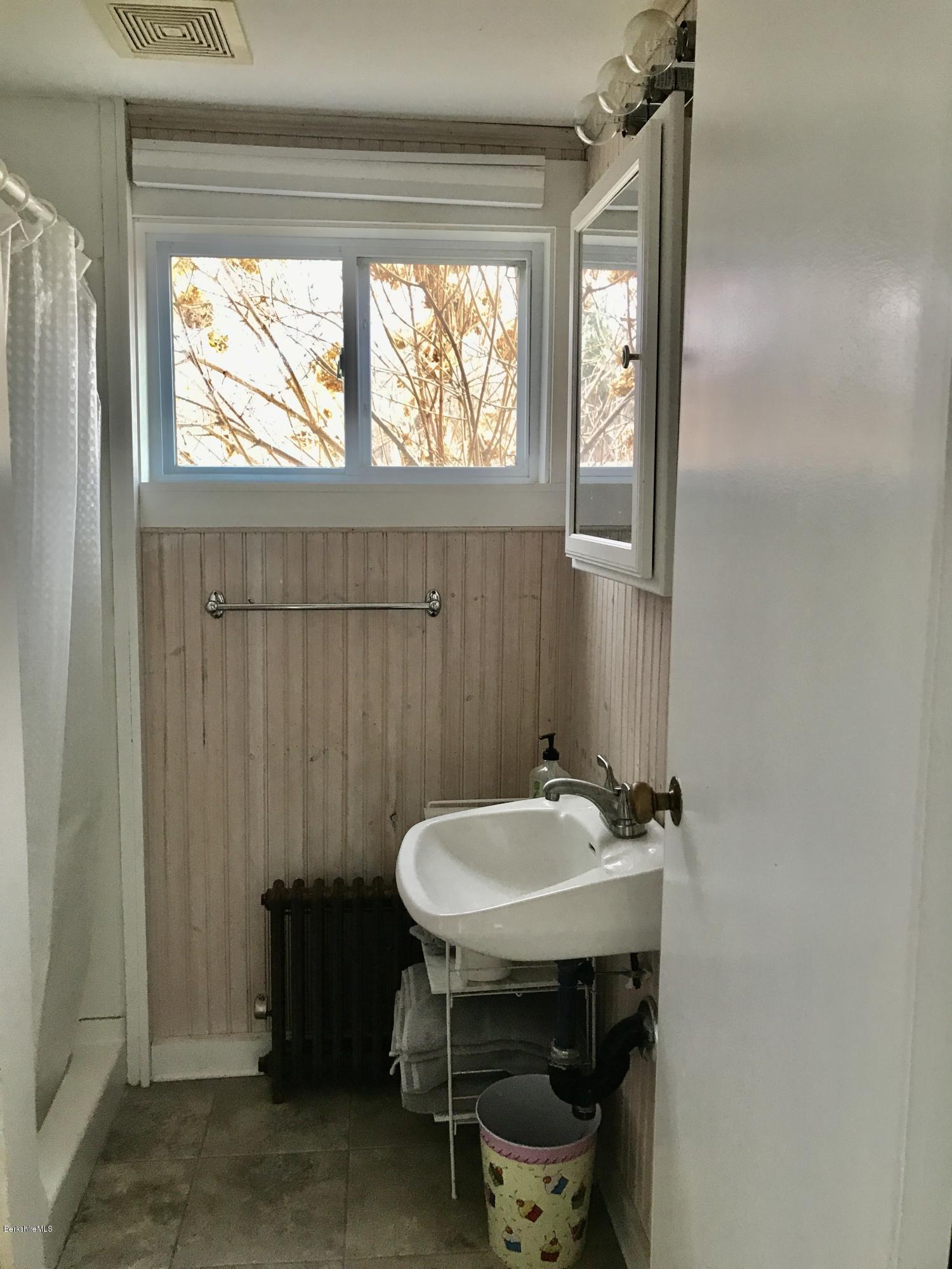 1679 Swamp Road Richmond, MA 01254 - Photo 15 of 33 a bathroom with a sink a mirror and a toilet