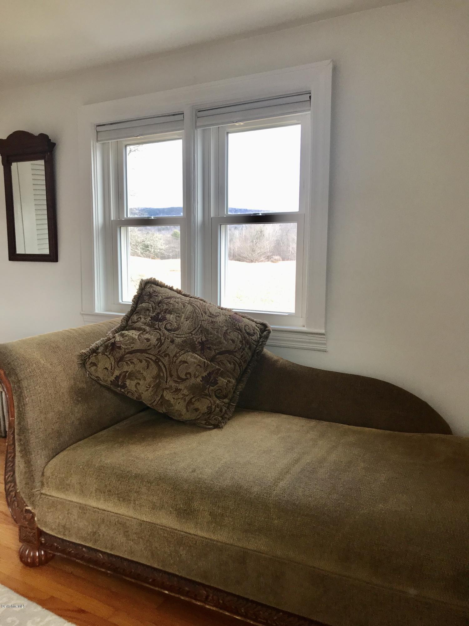 1679 Swamp Road Richmond, MA 01254 - Photo 18 of 33 a large bed sitting in a bedroom next to a window