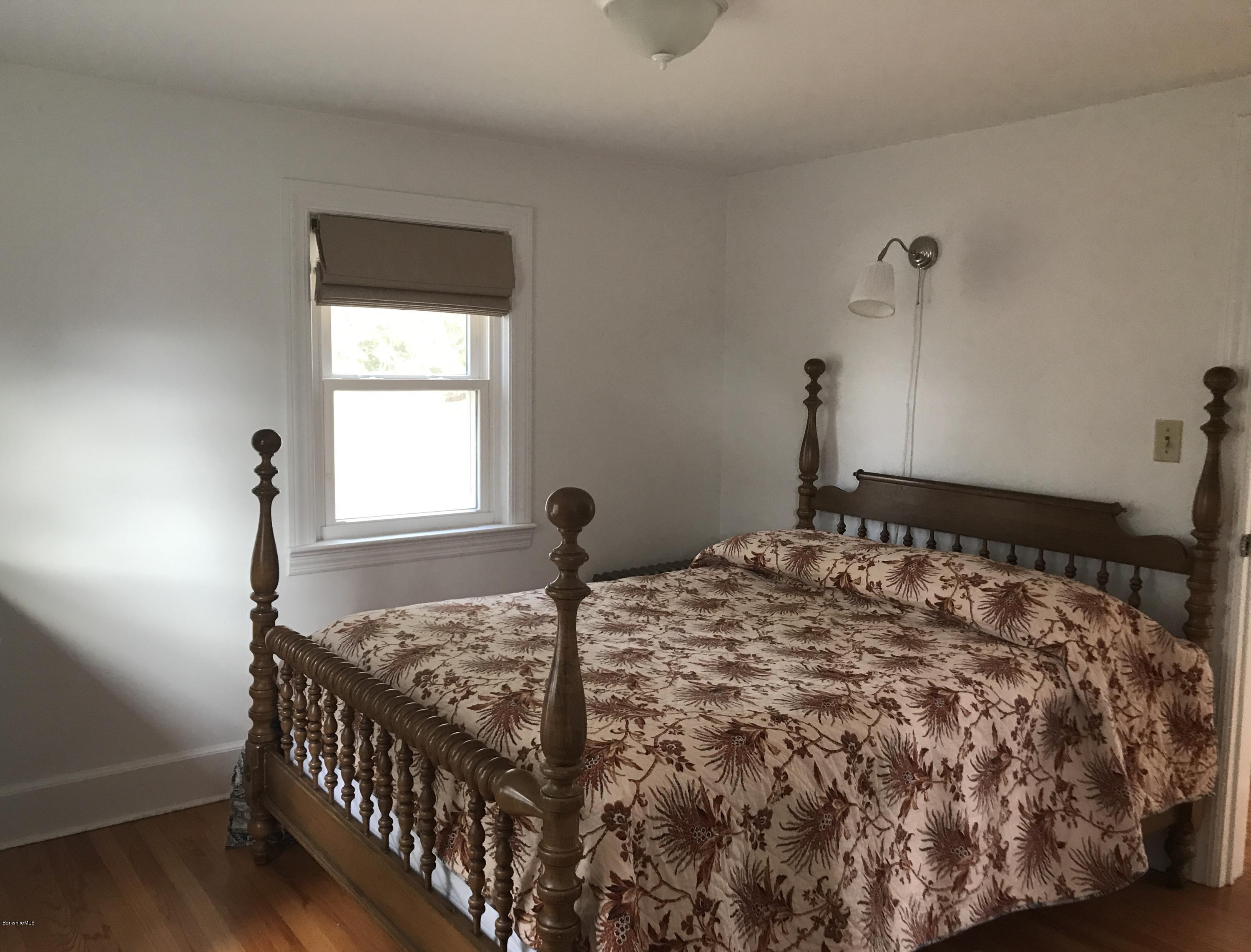 1679 Swamp Road Richmond, MA 01254 - Photo 21 of 33 a bed sitting in a bedroom next to a window