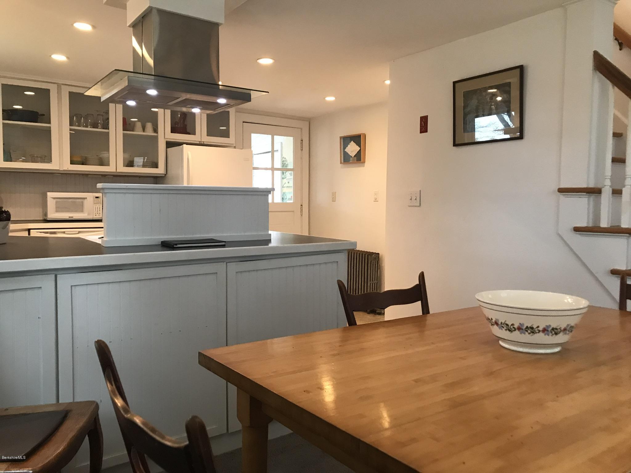 1679 Swamp Road Richmond, MA 01254 - Photo 9 of 33 a kitchen with a table chairs and a refrigerator