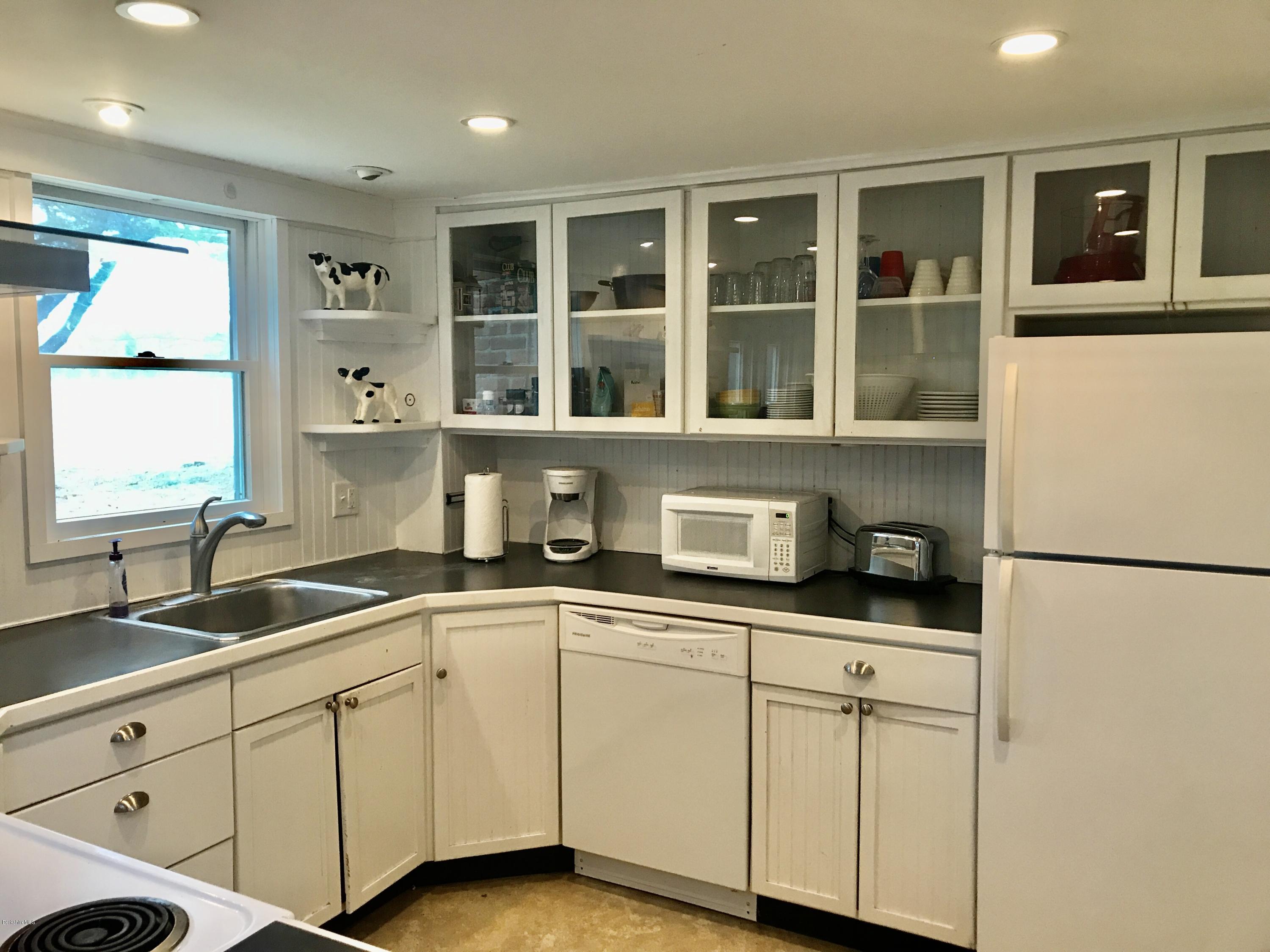 1679 Swamp Road Richmond, MA 01254 - Photo 10 of 33 a kitchen with granite countertop cabinets and window
