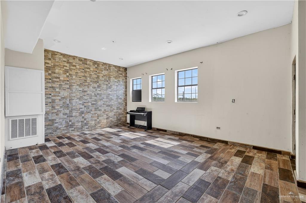 1424 North Sky Soldier Road Weslaco, TX 78596 - Photo 8 of 33 a view of a livingroom with wooden floor and a workspace