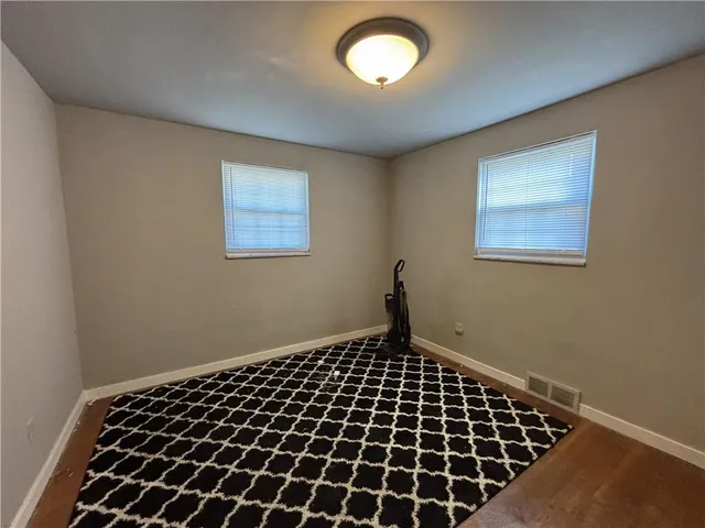 a view of a room with wooden floor