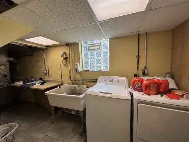 a kitchen with a sink appliances and cabinets