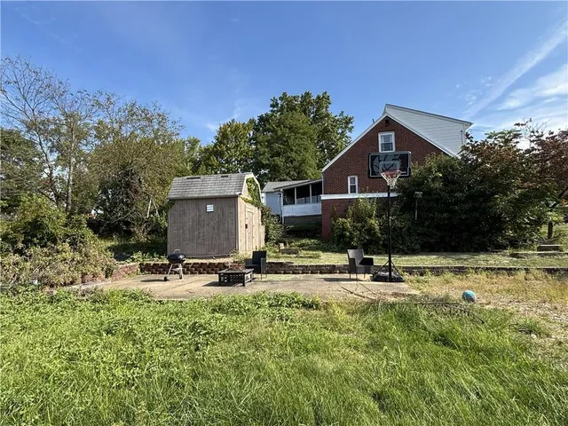 a backyard of a house with table and chairs