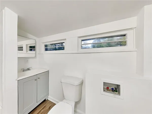 a bathroom with a toilet sink and mirror