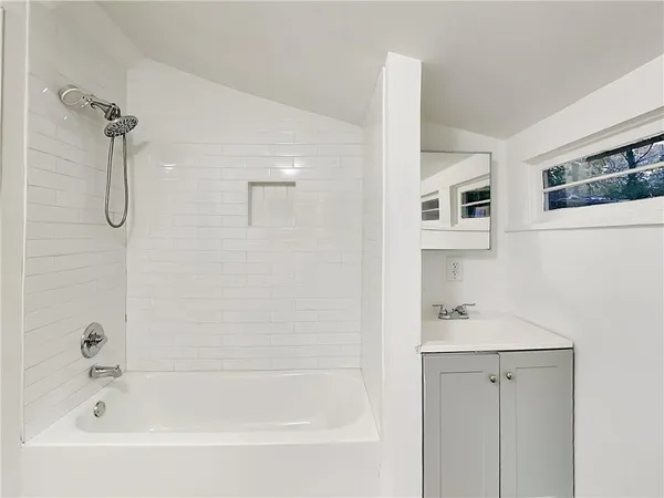 a white bath tub sitting next to a white sink