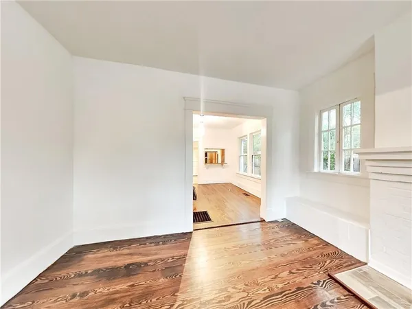 a view of a room with wooden floor and a window