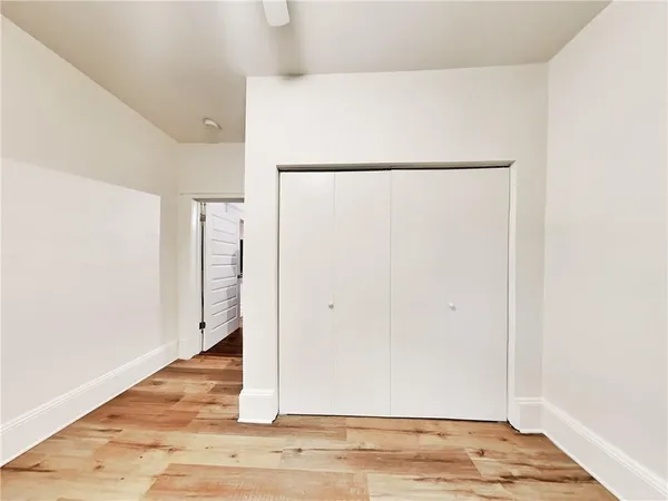 a view of a room with wooden floor