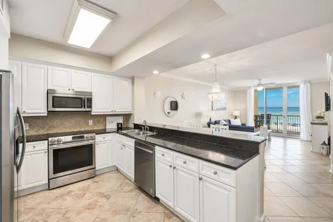 a kitchen with a stove sink and cabinets