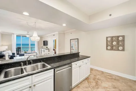 a kitchen with a sink and a stove top oven