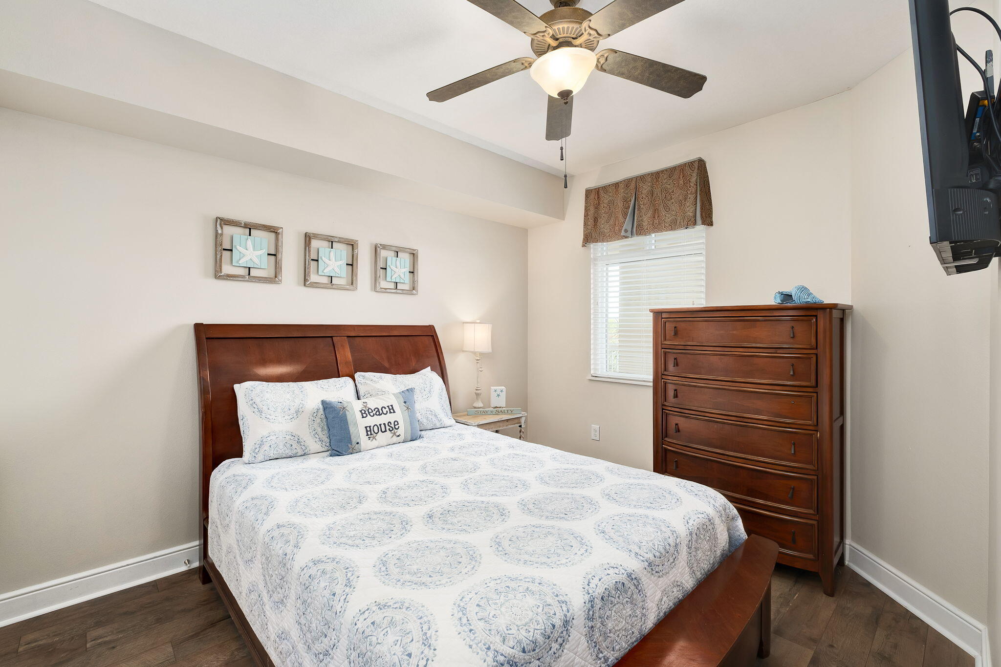 1150 Santa Rosa Boulevard, Unit 305 Fort Walton Beach, FL 32548 - Photo 22 of 43 a bedroom with a bed and a flat tv screen on dresser
