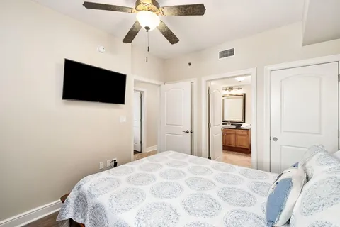 a bedroom with a bed and a flat screen tv