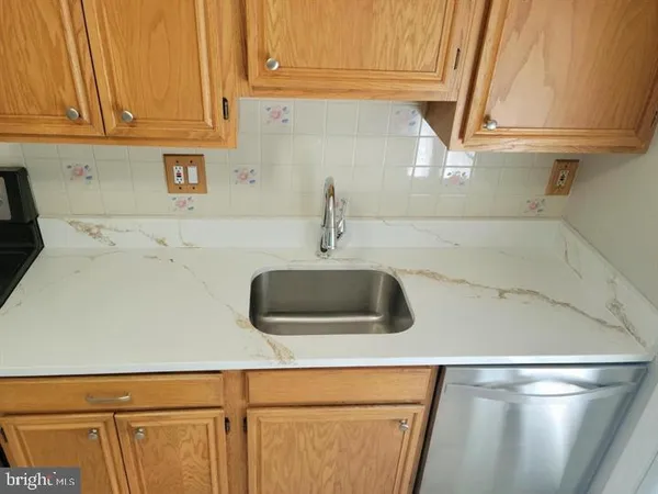 a kitchen with a sink and a refrigerator