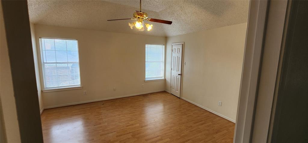 716 Violet Court Mesquite, TX 75150 - Photo 12 of 19 a view of an empty room with wooden floor and a window