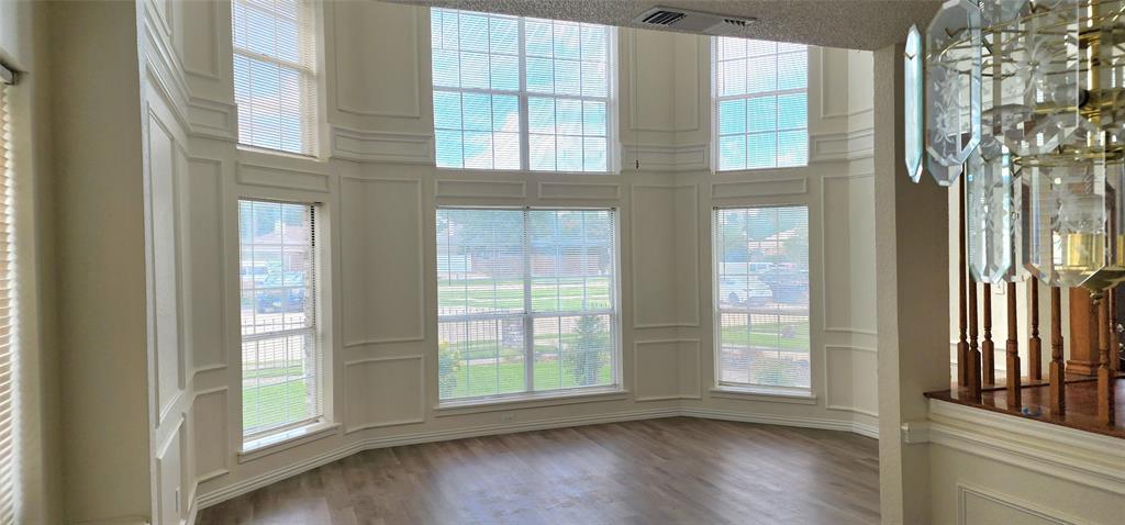 716 Violet Court Mesquite, TX 75150 - Photo 3 of 19 a view of an empty room with wooden floor and a window