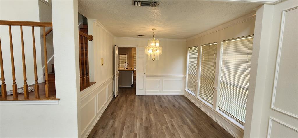 716 Violet Court Mesquite, TX 75150 - Photo 6 of 19 a view of a hallway with wooden floor and staircase