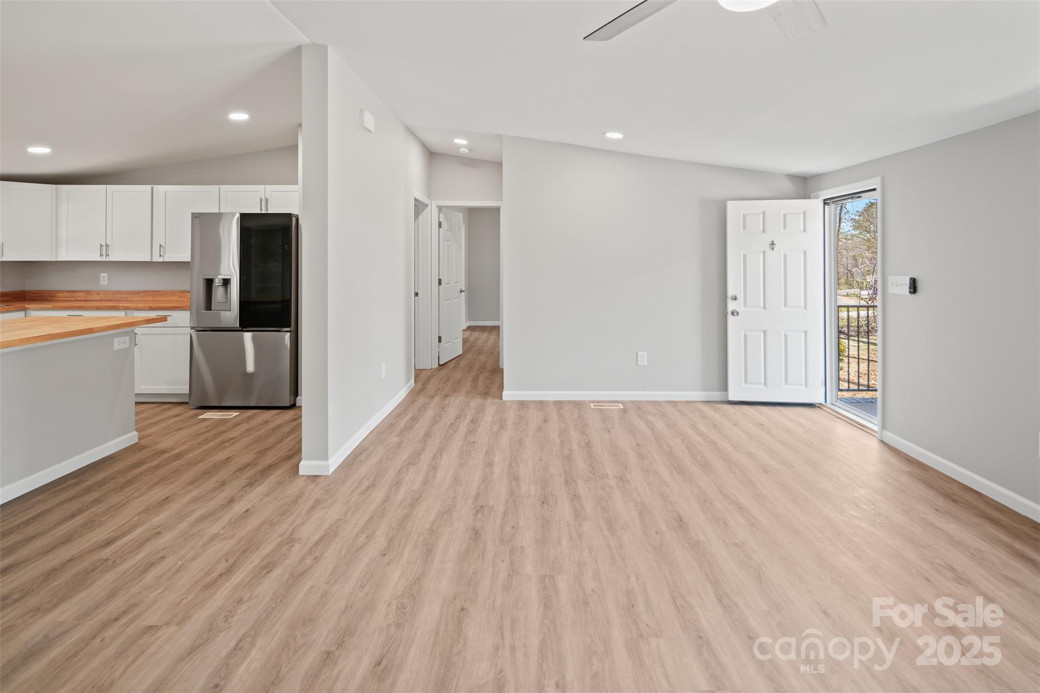 166 Brook Creek Drive Troutman, NC 28166 - Photo 11 of 26 a view of a big room with wooden floor and windows
