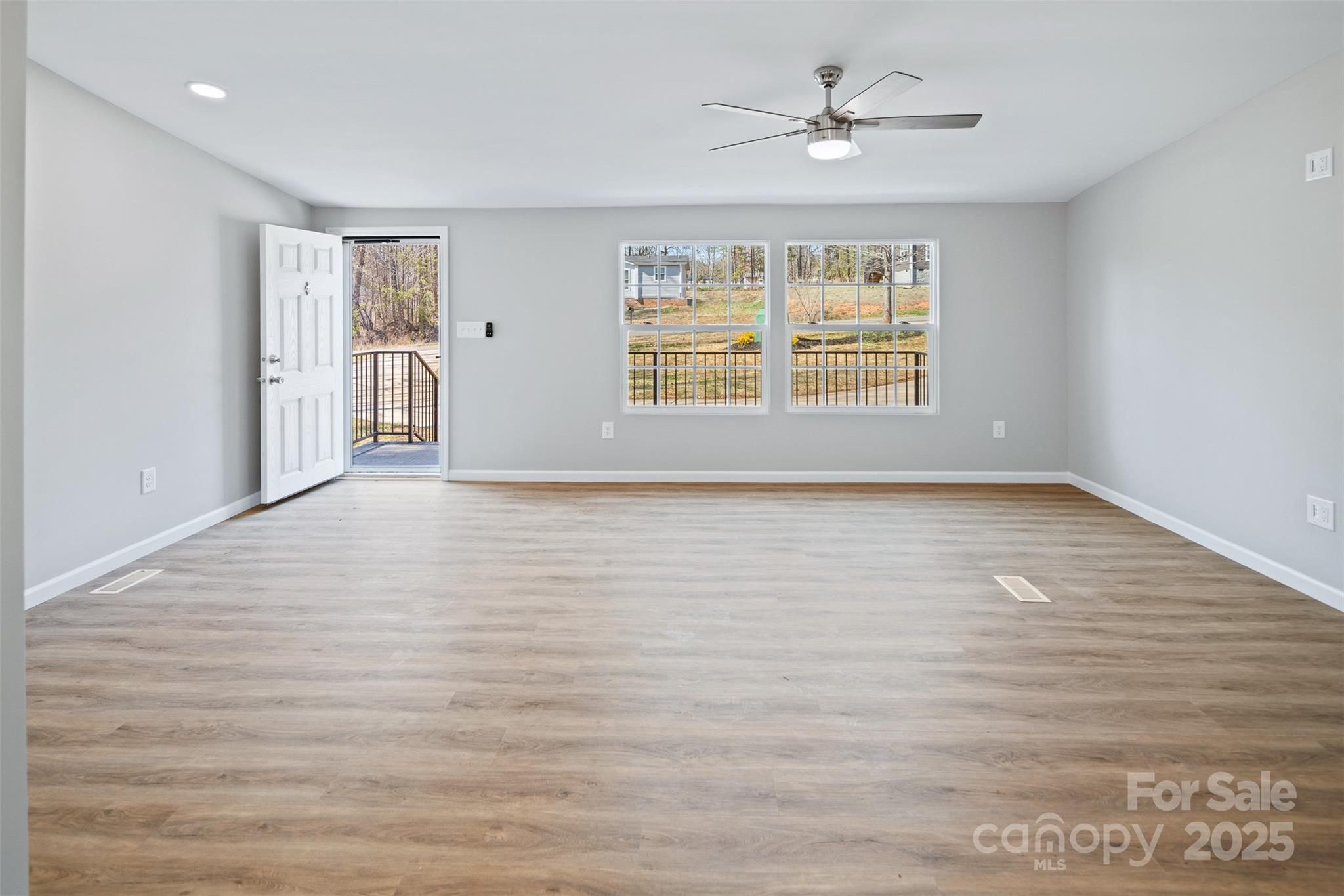 166 Brook Creek Drive Troutman, NC 28166 - Photo 12 of 26 wooden floor in an empty room with a window