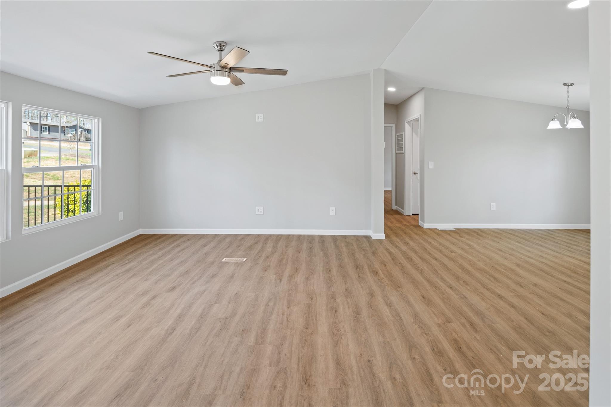 166 Brook Creek Drive Troutman, NC 28166 - Photo 13 of 26 wooden floor in an empty room with a window