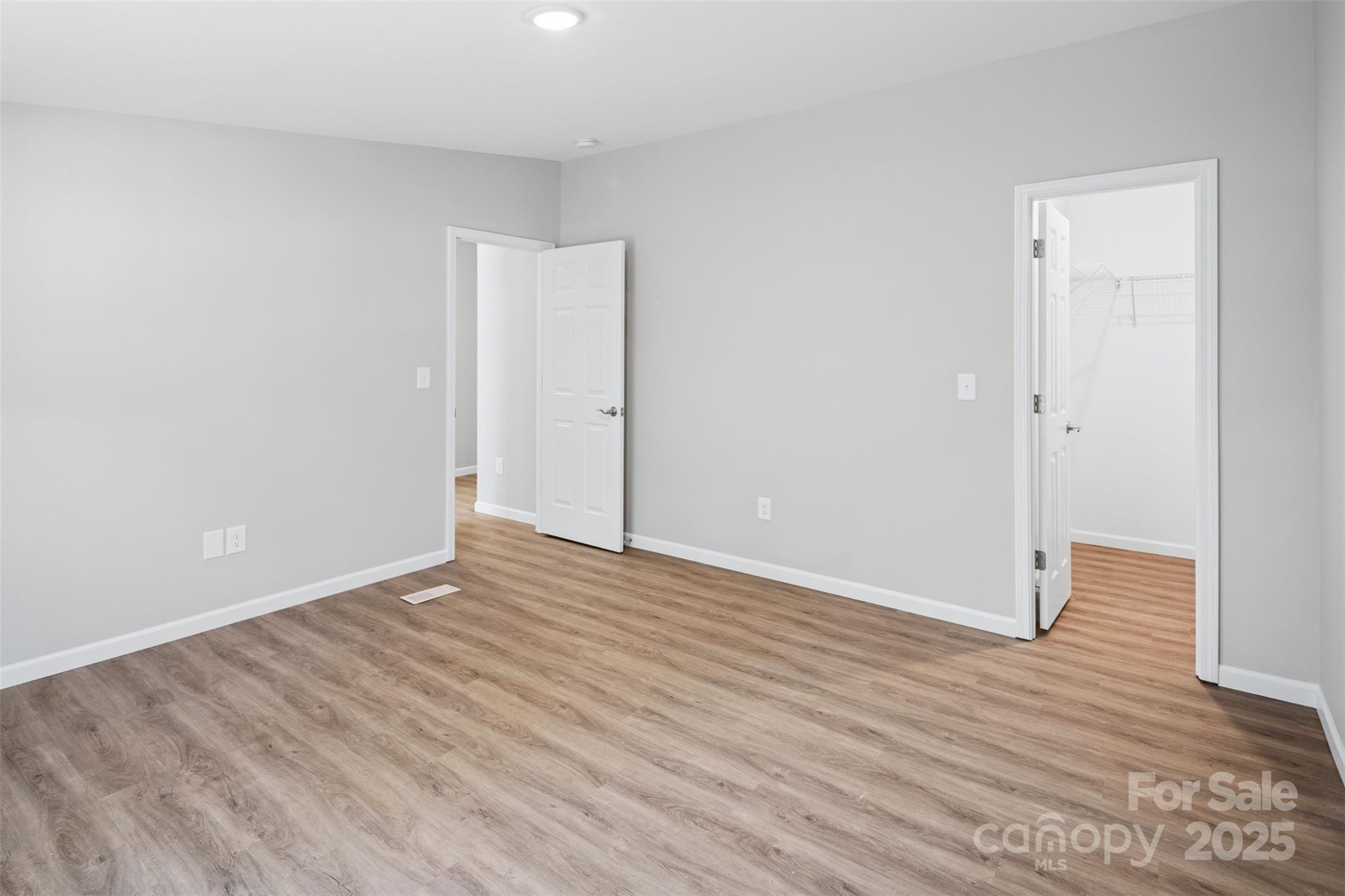 166 Brook Creek Drive Troutman, NC 28166 - Photo 21 of 26 a view of an empty room with wooden floor