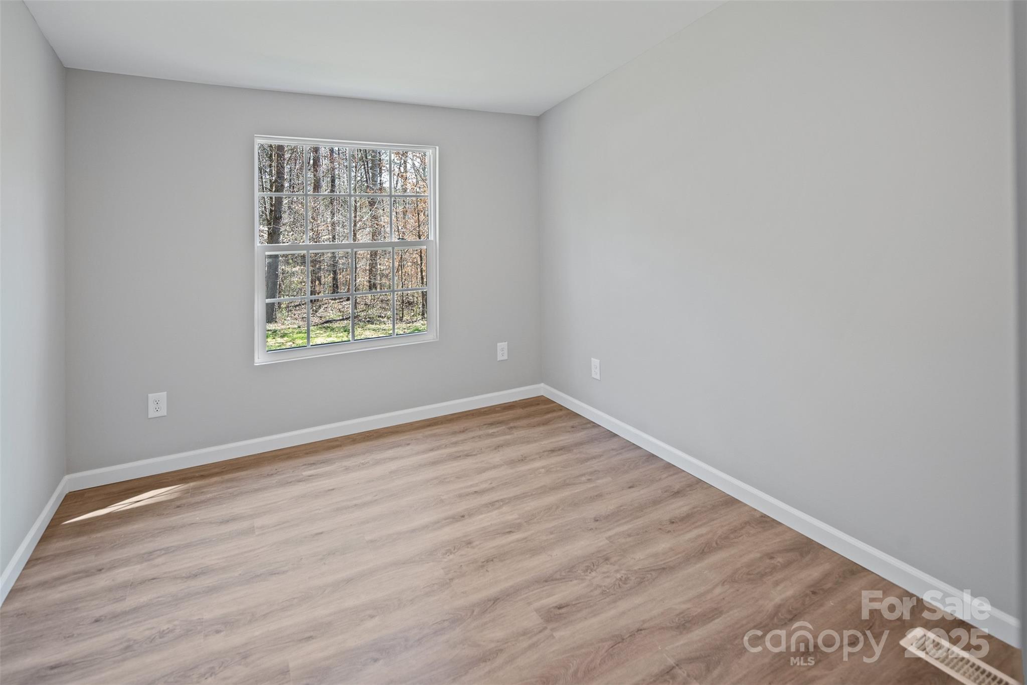 166 Brook Creek Drive Troutman, NC 28166 - Photo 25 of 26 wooden floor in an empty room with a window