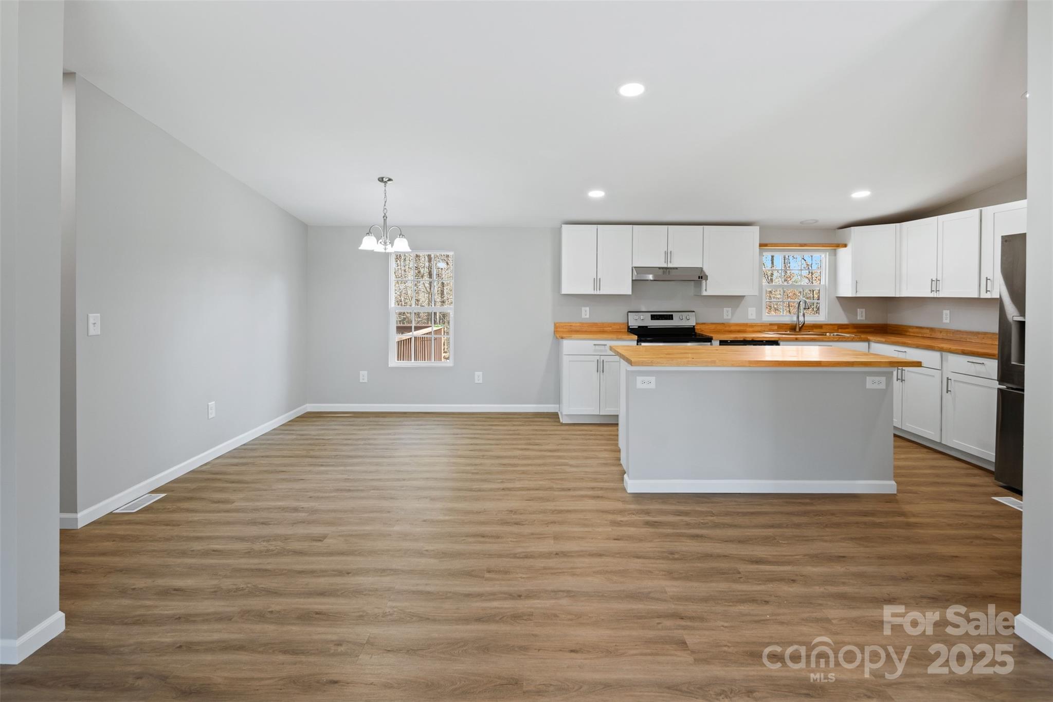 166 Brook Creek Drive Troutman, NC 28166 - Photo 10 of 26 a kitchen with stainless steel appliances granite countertop a sink a stove top oven a counter space and cabinets