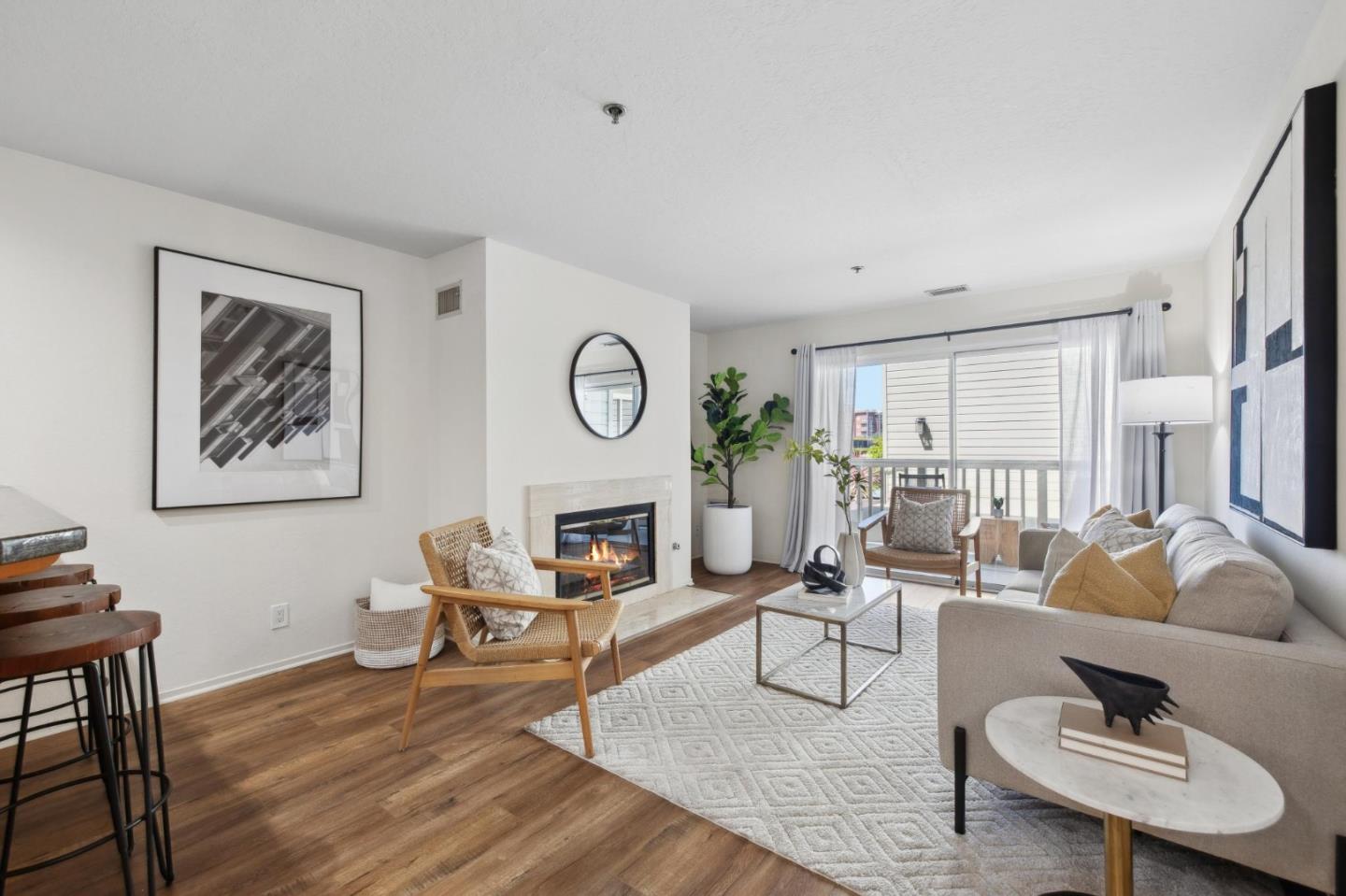 a living room with furniture a clock on wall and a window