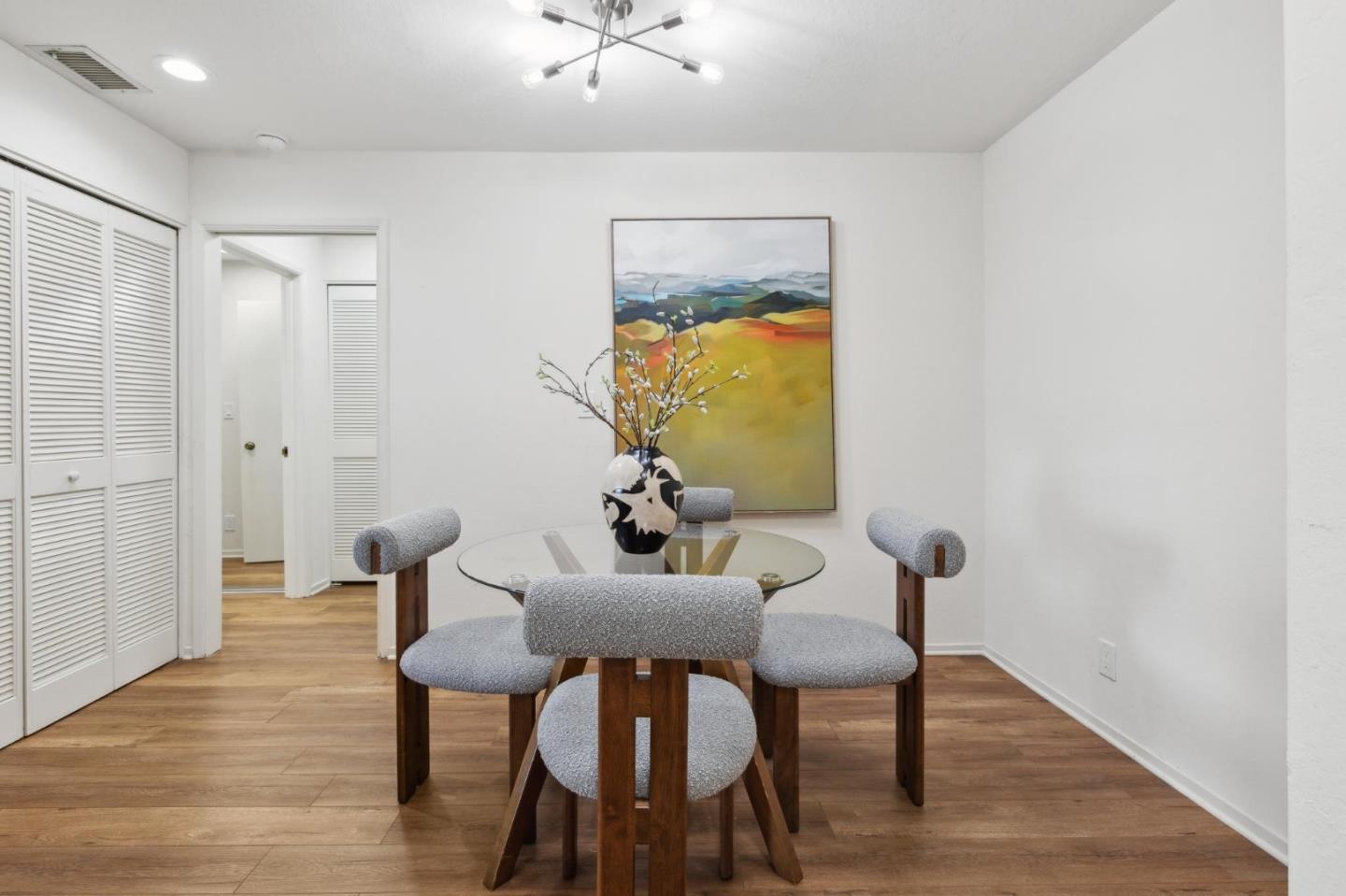 300 Murchison Drive, Unit 123 Millbrae, CA 94030 - Photo 11 of 25 a view of a dining room with furniture and wooden floor