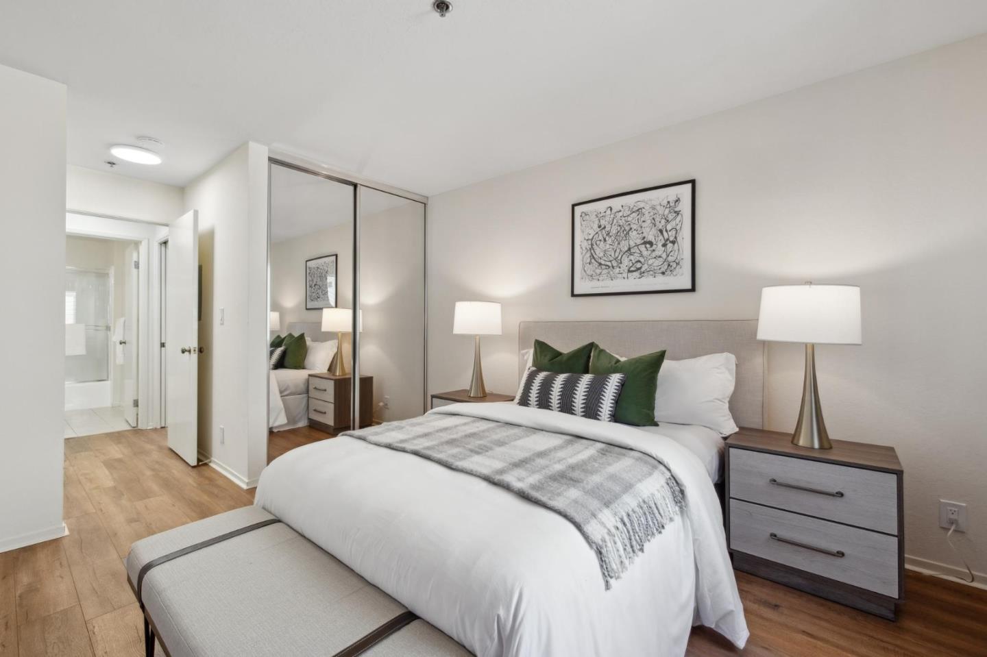 300 Murchison Drive, Unit 123 Millbrae, CA 94030 - Photo 13 of 25 a bedroom with a bed and a lamp