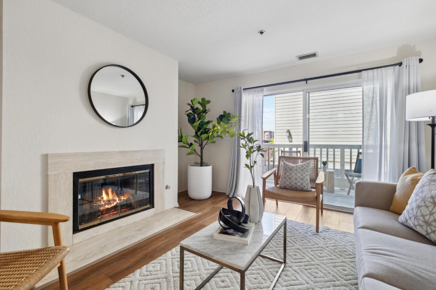 300 Murchison Drive, Unit 123 Millbrae, CA 94030 - Photo 3 of 25 a living room with furniture a window and a fireplace