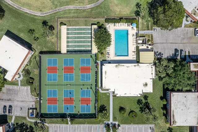 an aerial view of a residential apartment building with a yard
