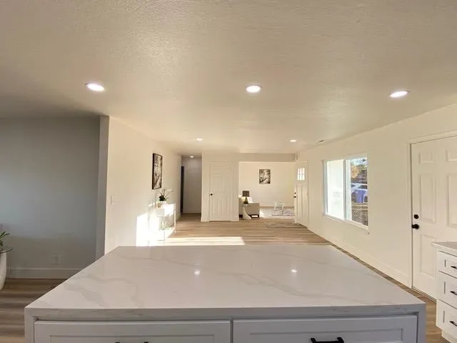 a large bedroom with a bed and a large window