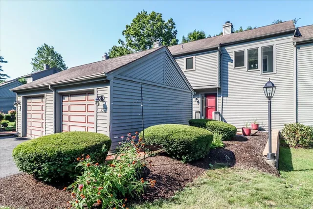 a view of a house with a small yard and plants