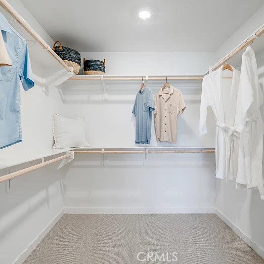 1734 Eagle Road Rialto, CA 92376 - Photo 17 of 23 a view of walk in closet with clothes and shoes