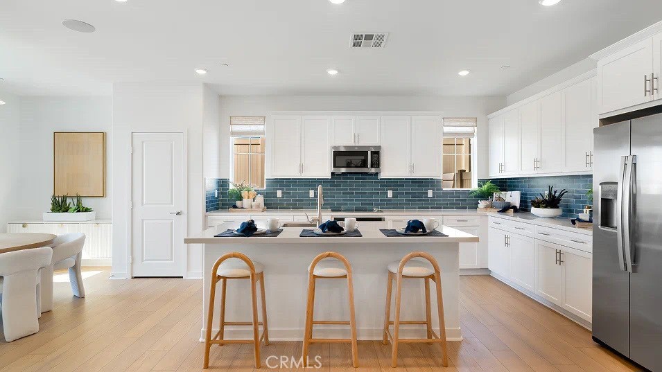 1734 Eagle Road Rialto, CA 92376 - Photo 2 of 23 a kitchen with stainless steel appliances granite countertop a stove a sink a refrigerator a dining table and chairs