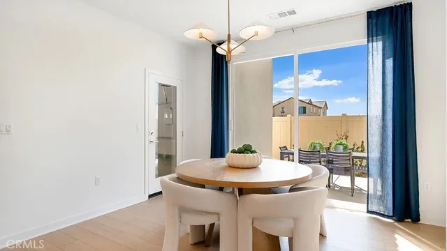 a kitchen with a table and a chandelier