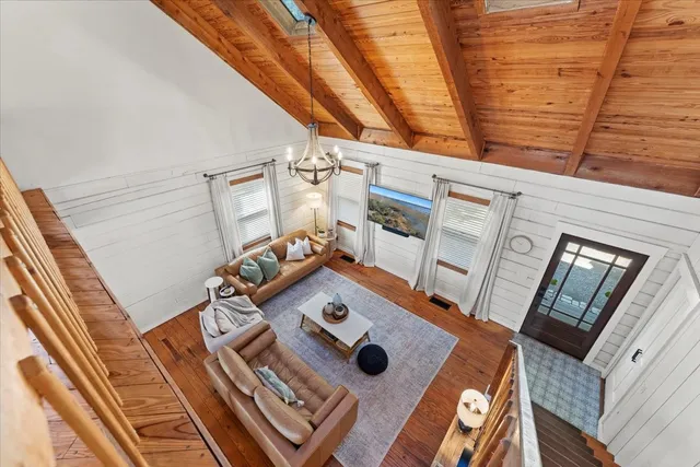 a view of a dining room with furniture wooden floor and chandelier