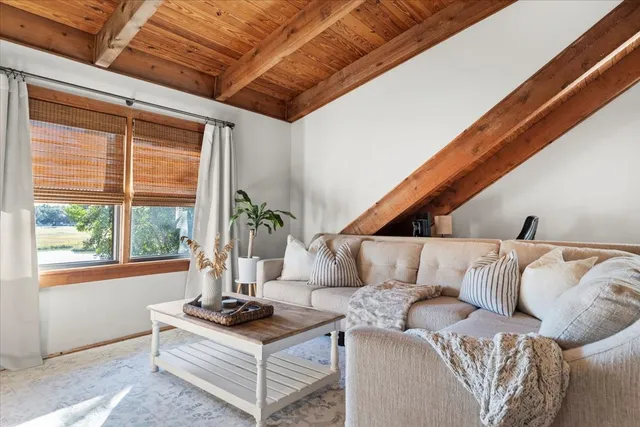 a picture of a room with a white wall and a large window