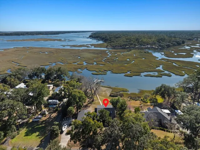 a view of an ocean with a house in the background