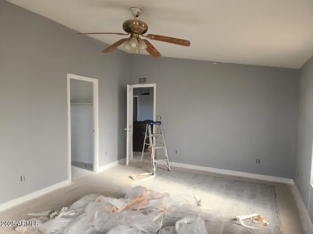 a view of a bedroom with a bed and hallway
