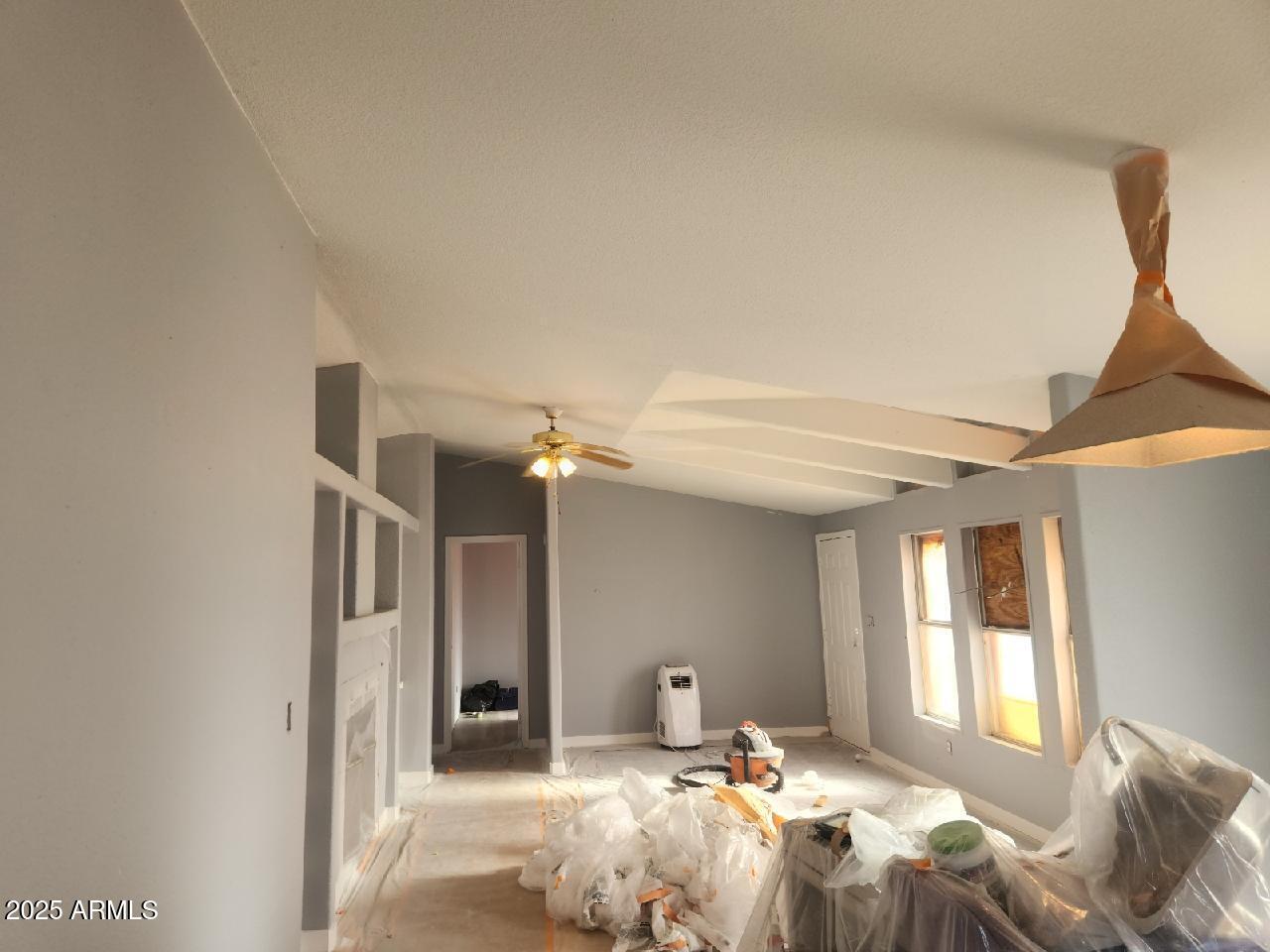 65623 Hall Street Salome, AZ 85348 - Photo 10 of 14 a bedroom with a bed large window and a chandelier