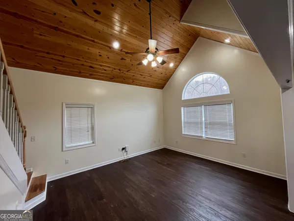 a view of a livingroom with wooden floor and a ceiling fan