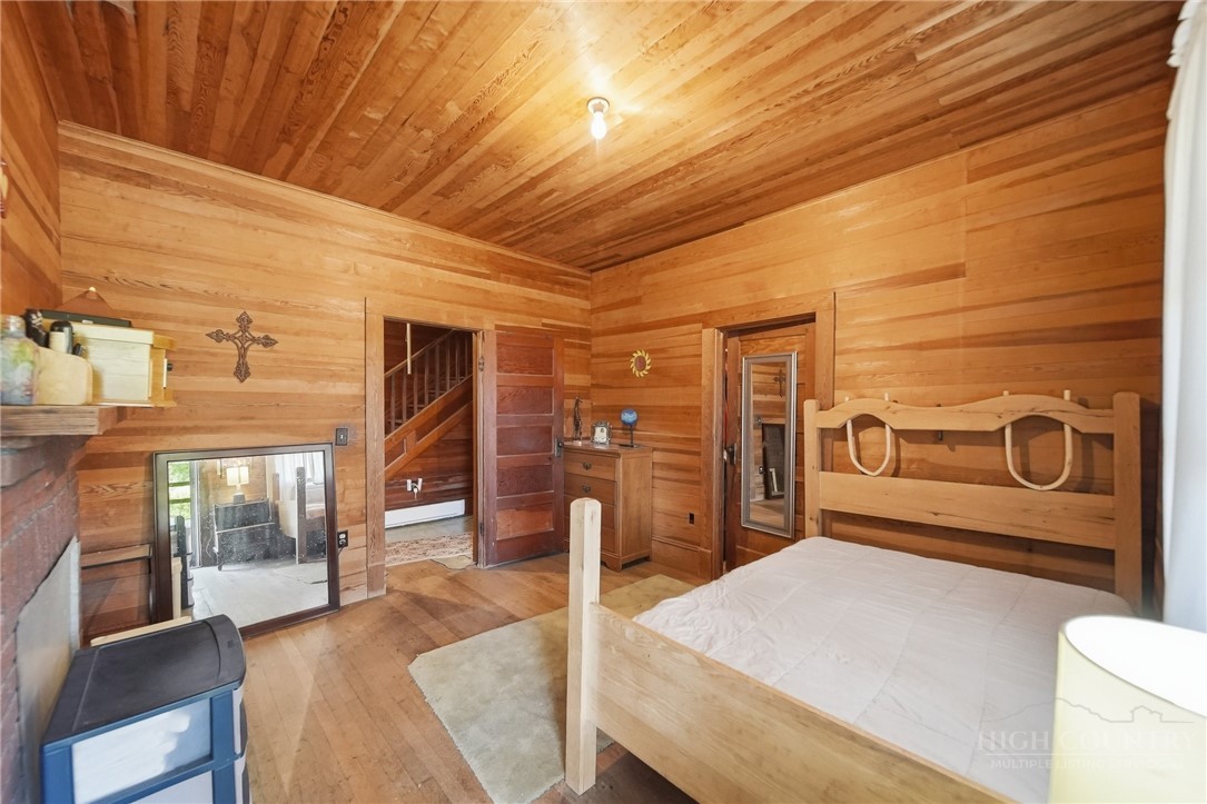 3450 Sparta Road North Wilkesboro, NC 28659 - Photo 11 of 34 a spacious bedroom with a bed and wooden floor