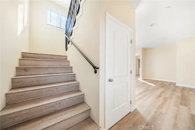 a view of empty room with wooden floor and window