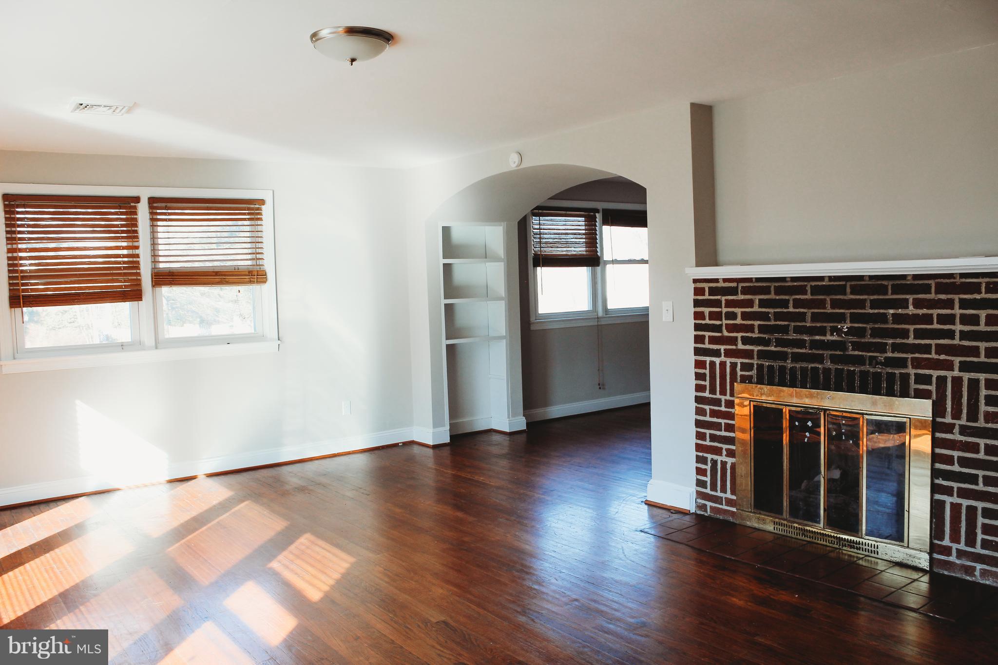 9101 Sudley Road Manassas, VA 20110 - Photo 15 of 19 a view of an empty room with window and wooden floor