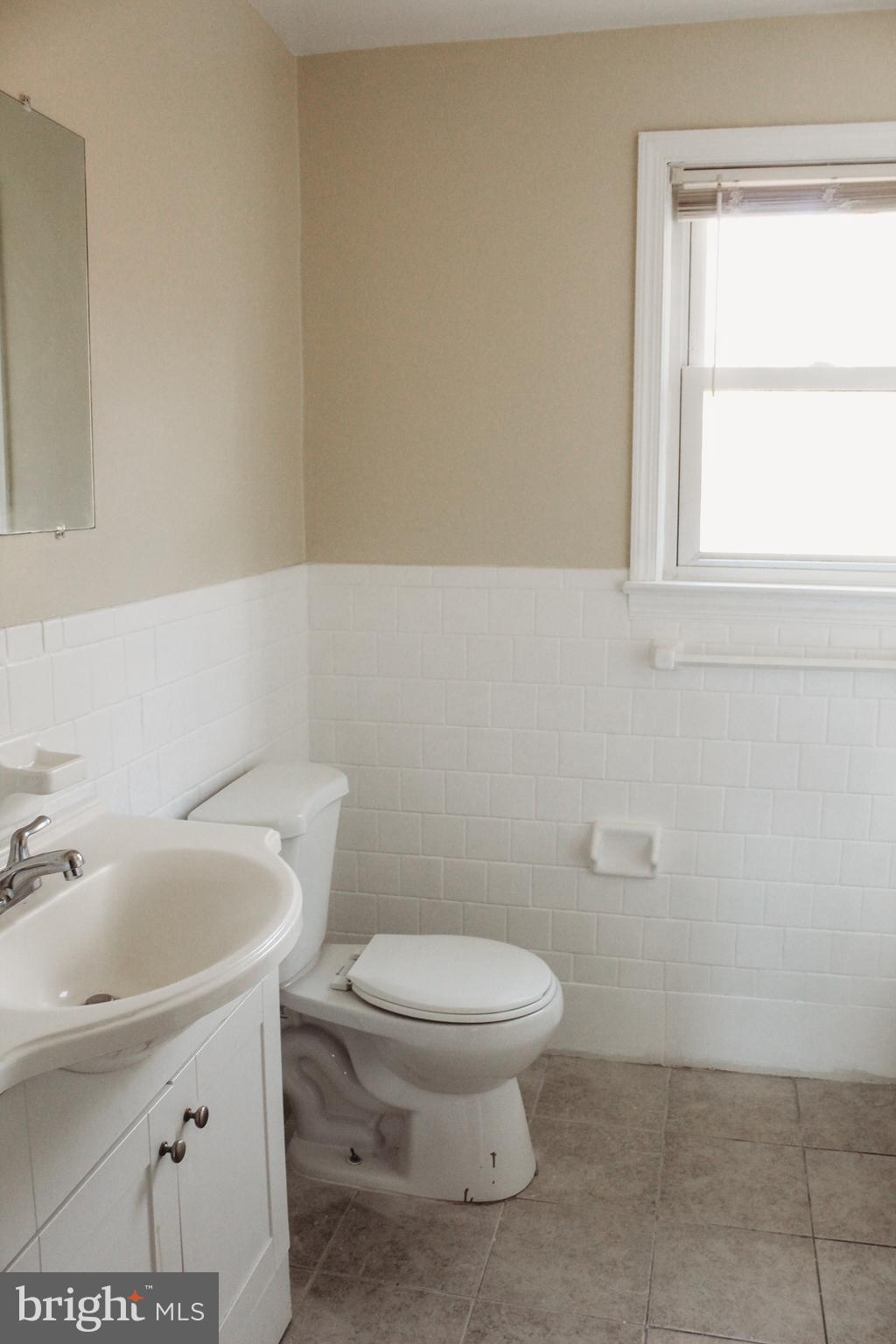 9101 Sudley Road Manassas, VA 20110 - Photo 16 of 19 a white toilet sitting next to a bathroom sink