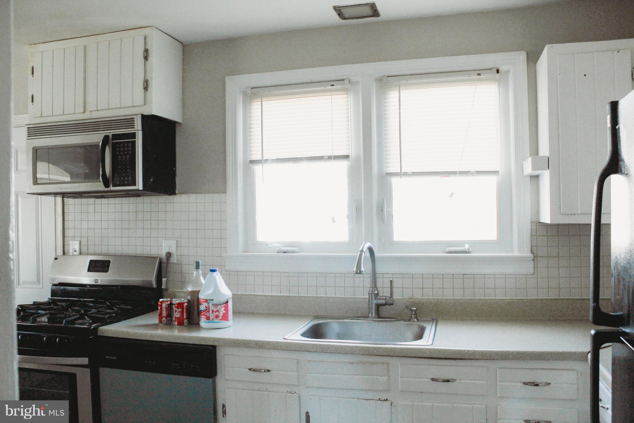 9101 Sudley Road Manassas, VA 20110 - Photo 19 of 19 a kitchen with appliances a sink and a window