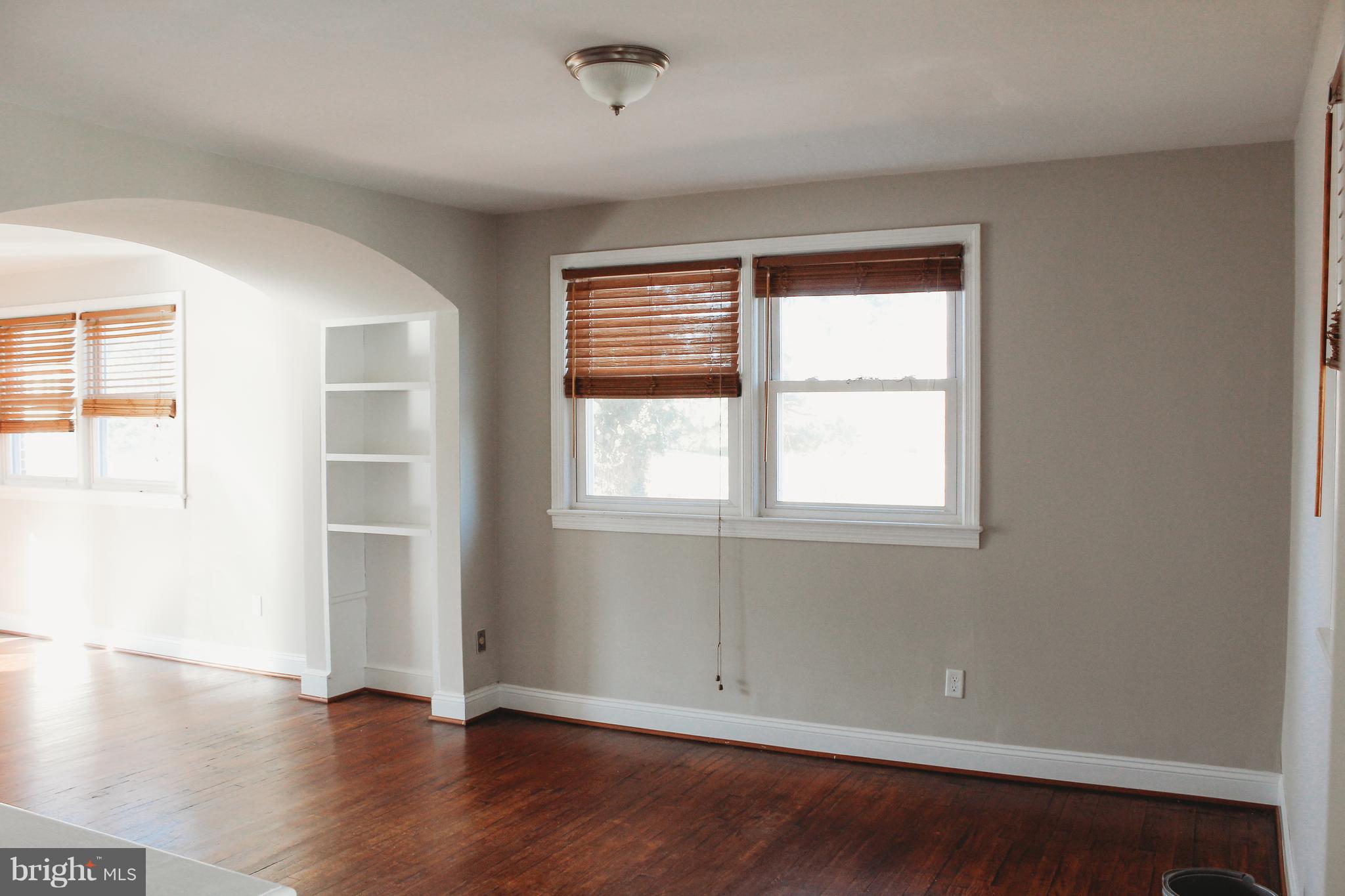 9101 Sudley Road Manassas, VA 20110 - Photo 4 of 19 an empty room with wooden floor and windows