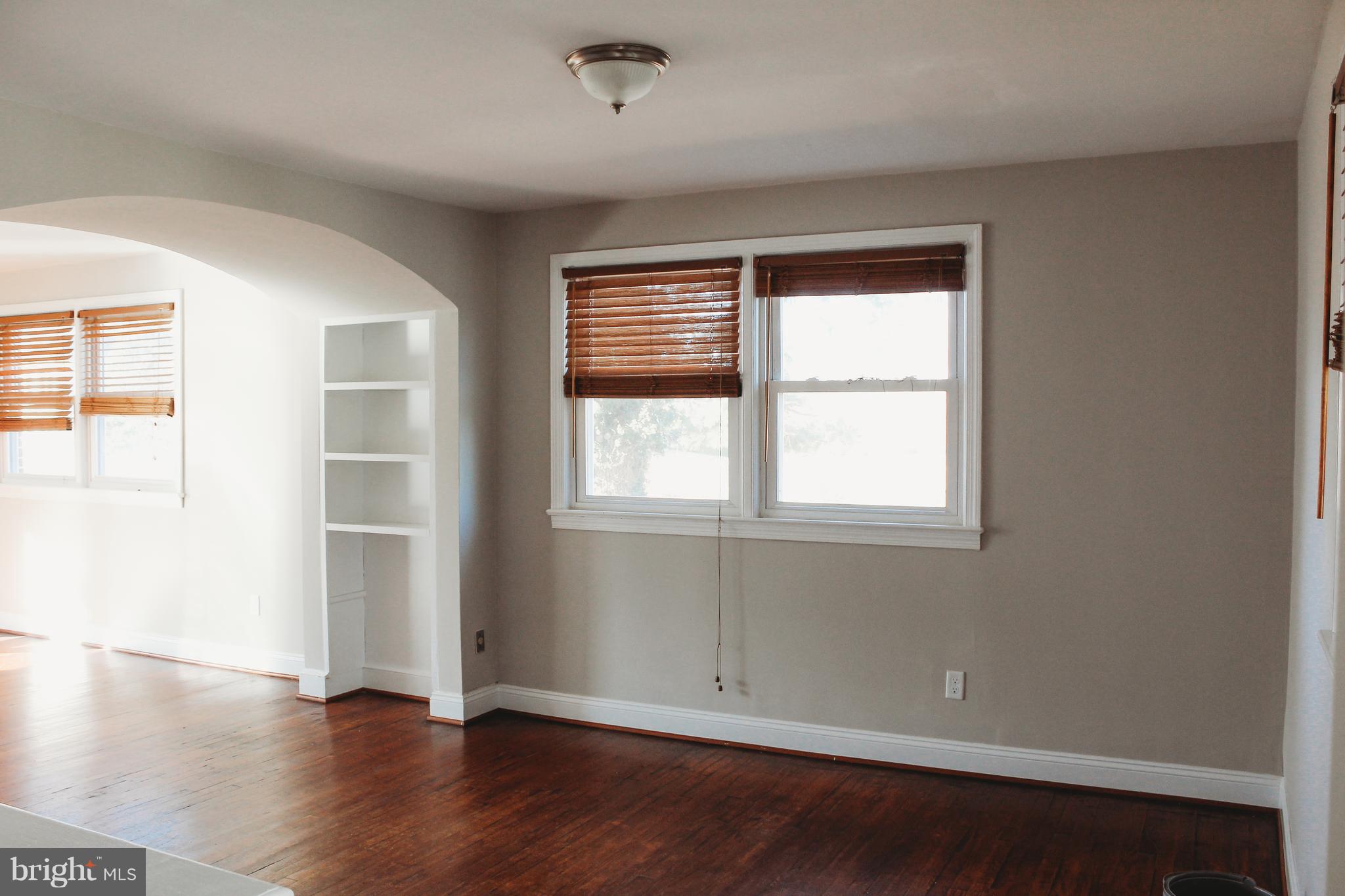 9101 Sudley Road Manassas, VA 20110 - Photo 5 of 19 an empty room with wooden floor and windows